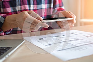 A man hand uses phone to scan bar code or qr code to pay for a credit card.