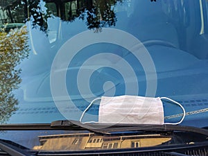 Man hand uses protective mask to open car door