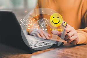Man hand using computer laptop with popup five star icon for feedback review satisfaction service, testimonial.