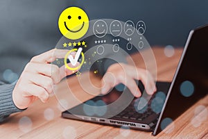 Man hand using computer laptop with popup five star icon for feedback review satisfaction service, testimonial.