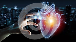 Man hand using digital x-ray of human heart holographic scan projection 3D rendering