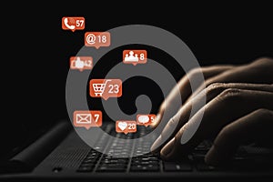 Man hand using laptop computer with Social media and business icons for technology and marketing concept