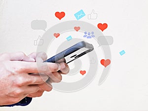 Man hand using smartphone with social media icons.