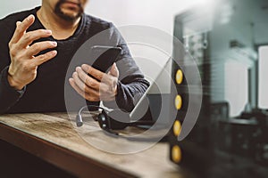 man hand using VOIP headset with smart phone and digital tablet