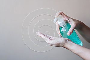 Man hand using wash hand sanitizer gel dispenser, against Novel coronavirus or Corona Virus Disease Covid-19 at public Indoor.