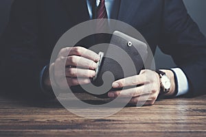 Man hand wallet and money on table