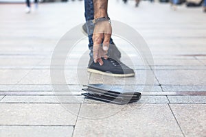 man hand wallet in street floor background.