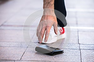 Man hand wallet in street floor