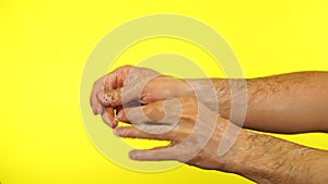 Man hand are washing with soap bubbles. Cleaning hands with white soap bubbles on yellow background