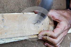 Man hand working on wood with a hammer