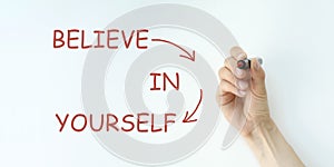 Man Hand writing Believe in Yourself with red marker on visual scr