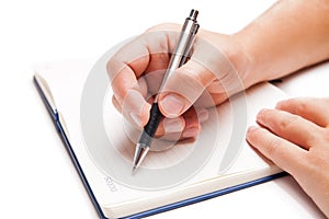 Man hand writing in open book on white