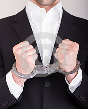 Man with handcuffs, business suit