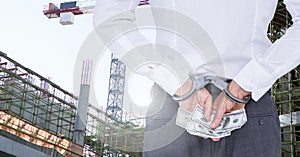 Man with handcuffs holding dollar banknotes