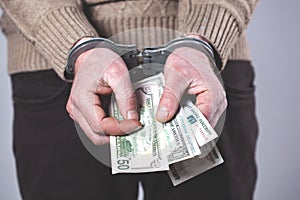 Man handcuffs and money