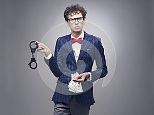 Man with handcuffs and money