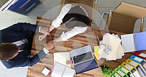 Man handcuffs woman for monetary bribe at workplace top view