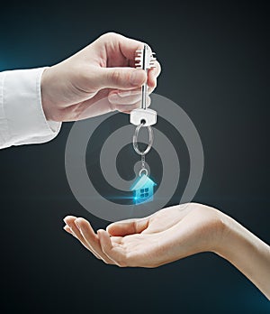 Man is handing a house key to a woman