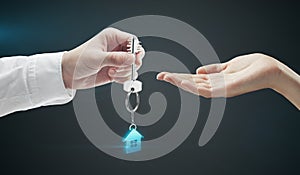 Man is handing a house key to a woman