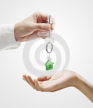 Man is handing a house key to a woman