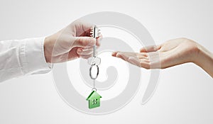 Man is handing a house key to a woman