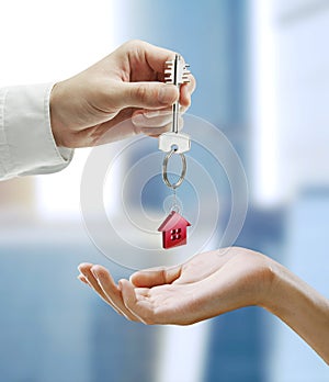Man is handing a house key to a woman