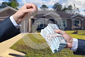 Man Handing a man Thousands of Dollars For Keys in Front of House.