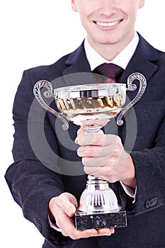 Man handing a trophy ove