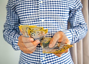 Man handling fifty dollar notes finance.