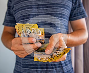 Man handling fifty dollar notes finance.