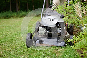 Man handling lawn with lawnmower