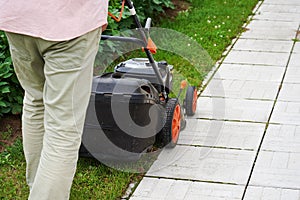 Man handling lawn with lawnmower