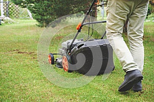 Man handling lawn with lawnmower