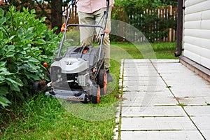 Man handling lawn with lawnmower