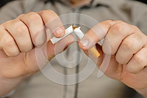 Man hands breaking the cigarette. Stop smoking in car concept. destroy cigarette by hand