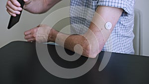 A man hands brings to the hand the smartphone for measuring glucose in the blood