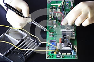 Man hands chip soldering tools