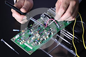 Man hands chip soldering tools