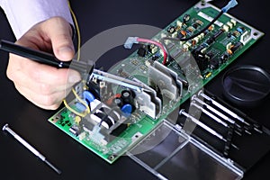 Man hands chip soldering tools