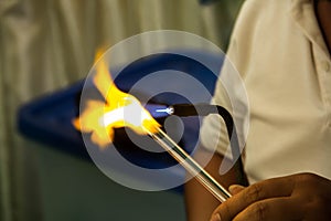 Man Hands Closeup Working on a Blown Glass Piece