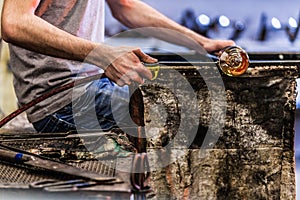 Man Hands Closeup Working on a Blown Glass Piece