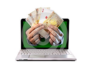 Man hands comming outlaptop holding euro banknotes and ace poker playing cards