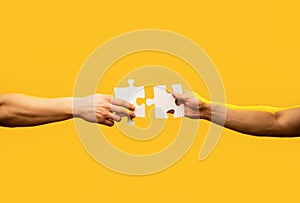 Man hands connecting couple puzzle piece. Business solutions, target, success, goals and strategy concepts. Hand