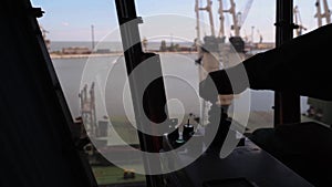 Man hands control joysticks at grain terminal operator cabin workplace. Worker controlling loading grain with arm lever