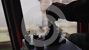 Man hands control joysticks at grain terminal operator cabin workplace. Worker controlling loading grain with arm lever