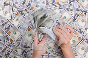 Man hands counting 100 dollar bills. In the hands of a lot of cash