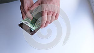 Man hands counting euro banknotes and puts in a wallet. Finance and business concept. Selective focus. Close-up