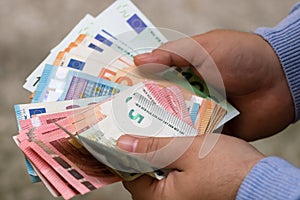 Man hands counting money, counting EURO currency, close up