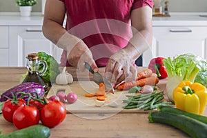 Man hands cutting vegetables in the kitchen