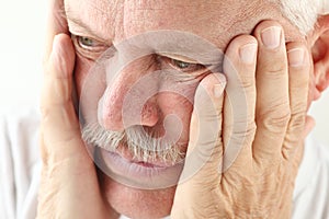 Man with hands on face